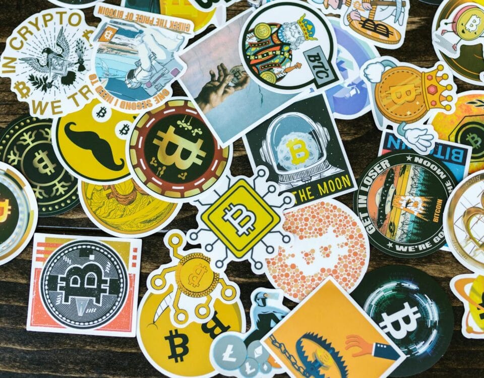 Colorful collection of Bitcoin-themed stickers on a wooden background, ideal for cryptocurrency concepts.