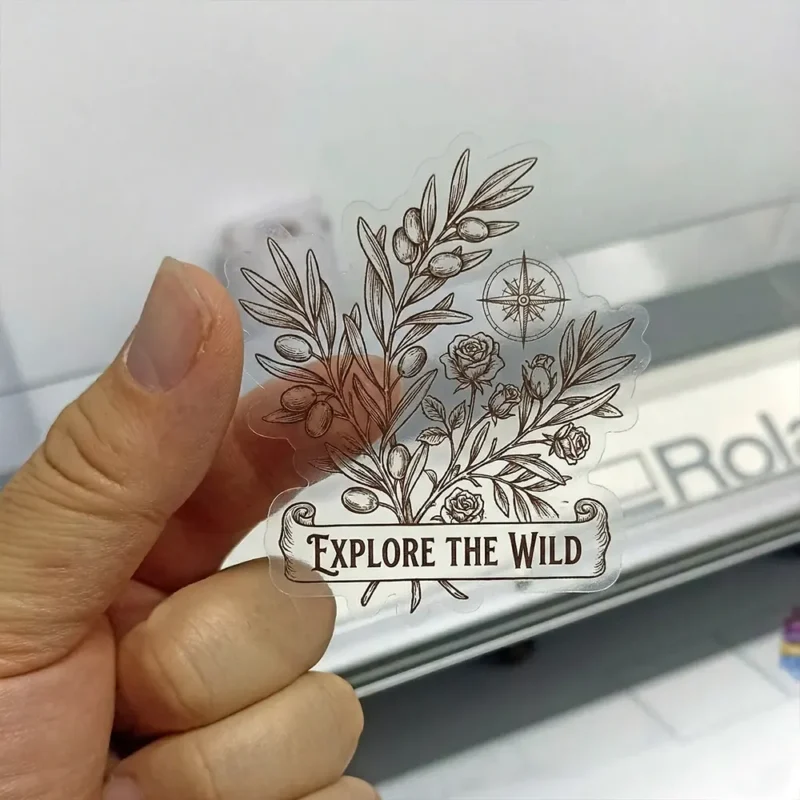 Transparent die cut sticker with a botanical Explore the Wild design